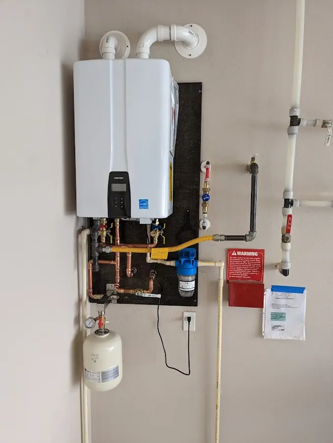 Professional plumber installing copper piping in a Minden home